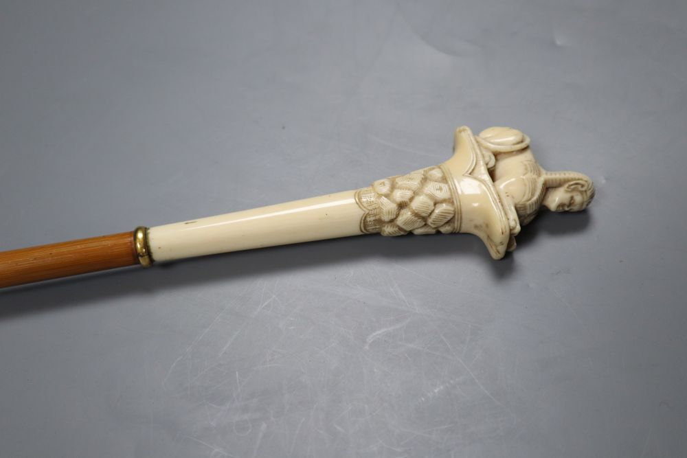 An ivory sphinx parasol handle, 84cm